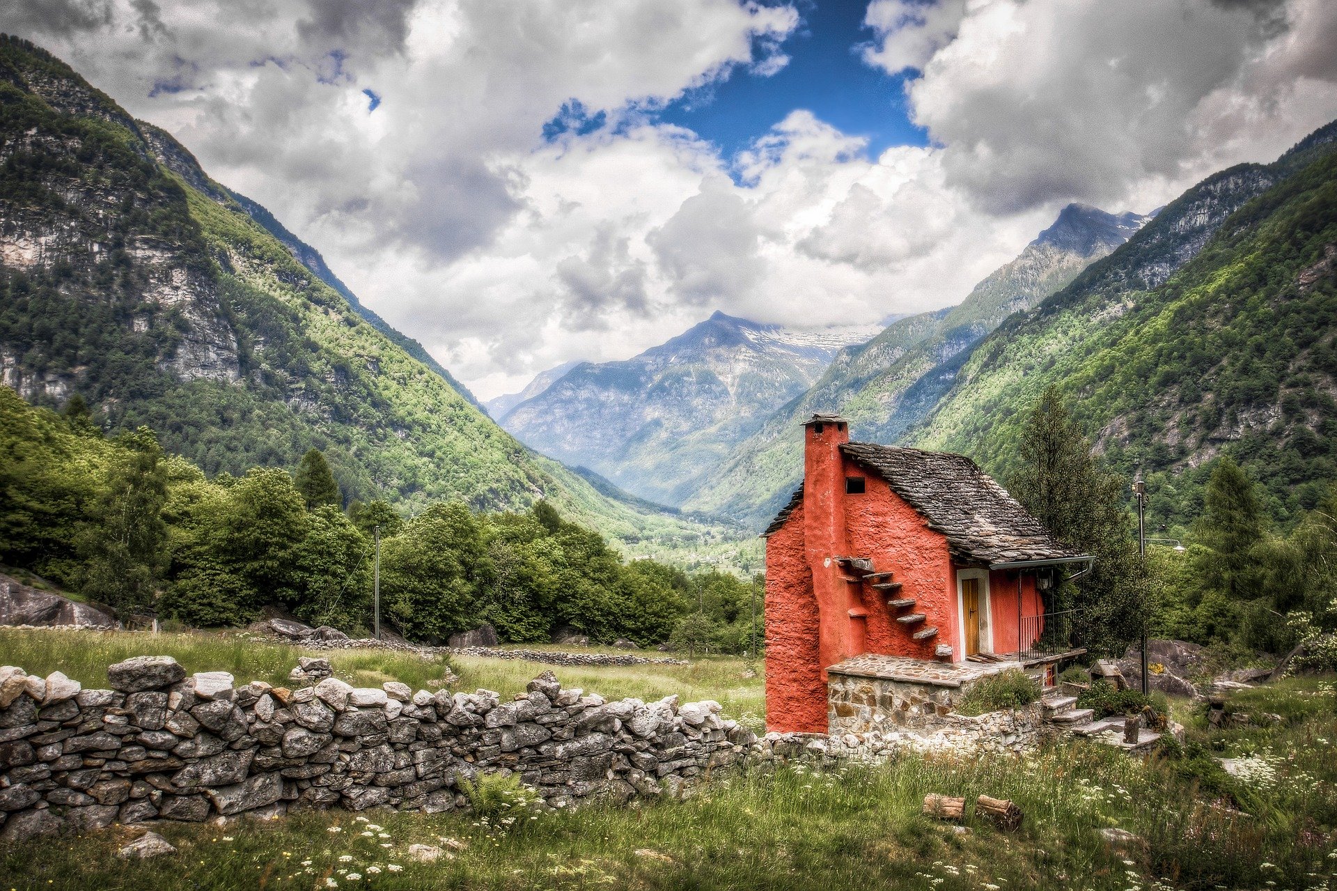 red brick house in between mountains