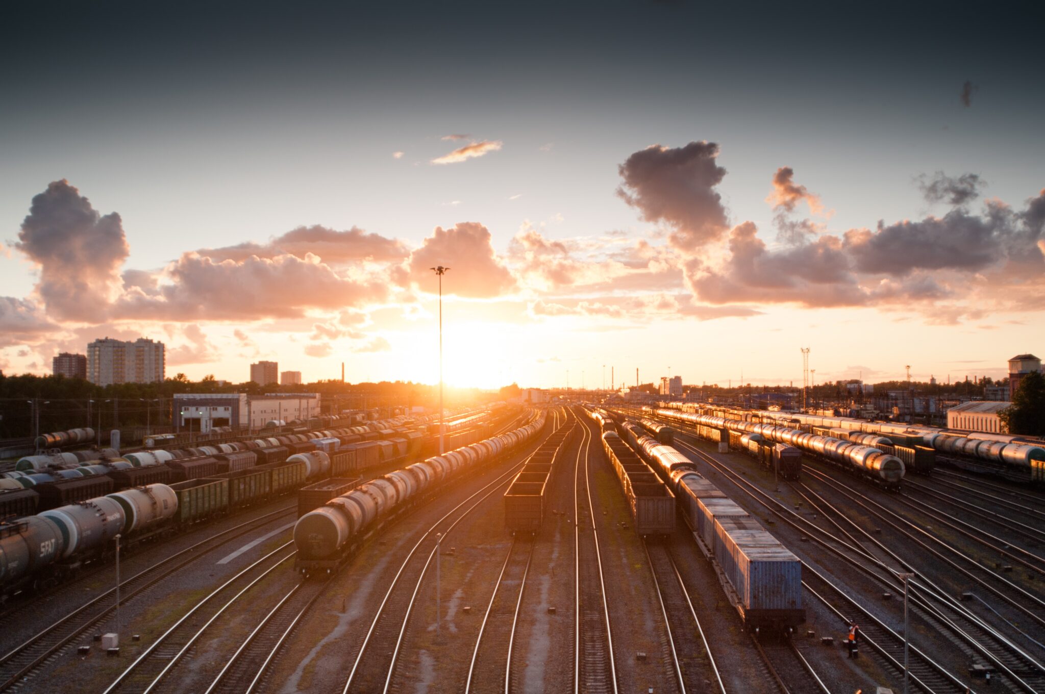 trains on tracks during sunset