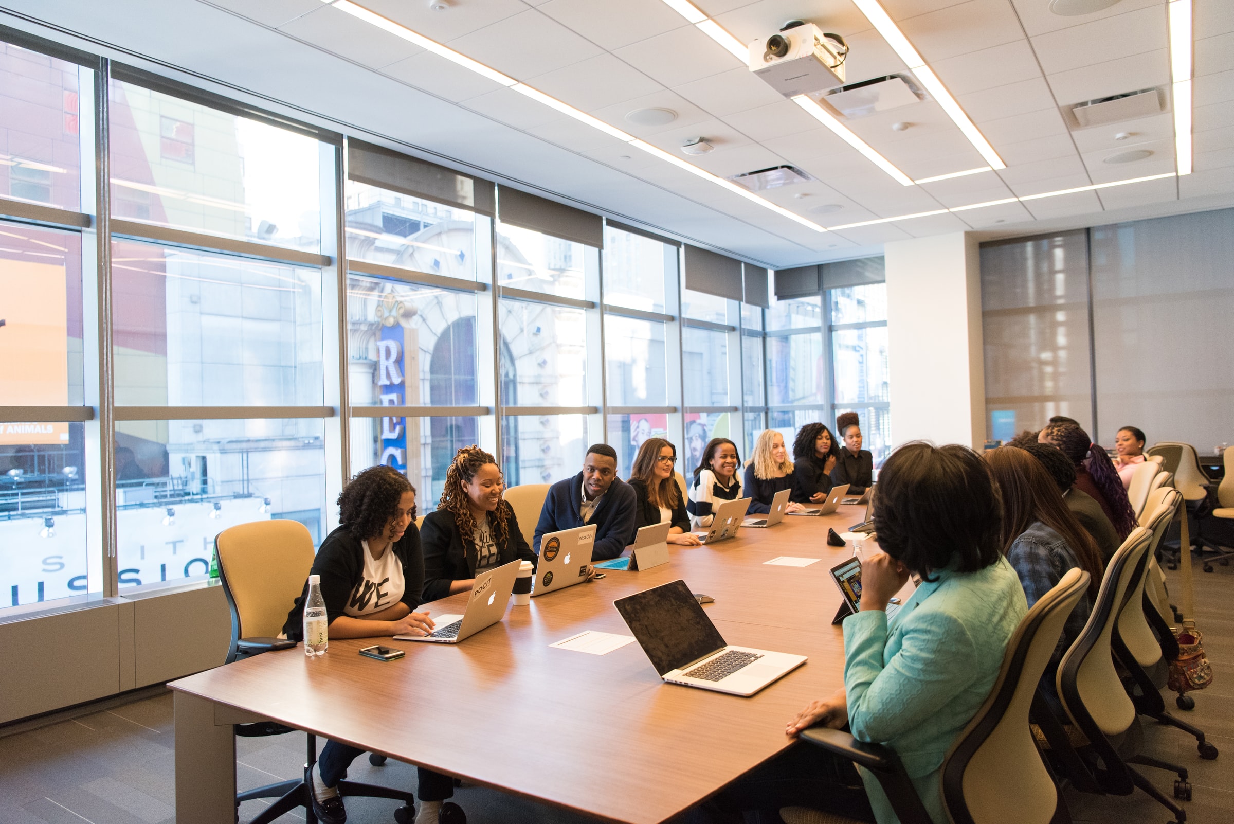 multiple employees in large office meeting